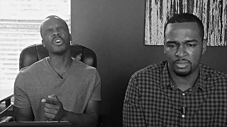 Two men telling jokes, one laughing and one serious, in a humorous setting.