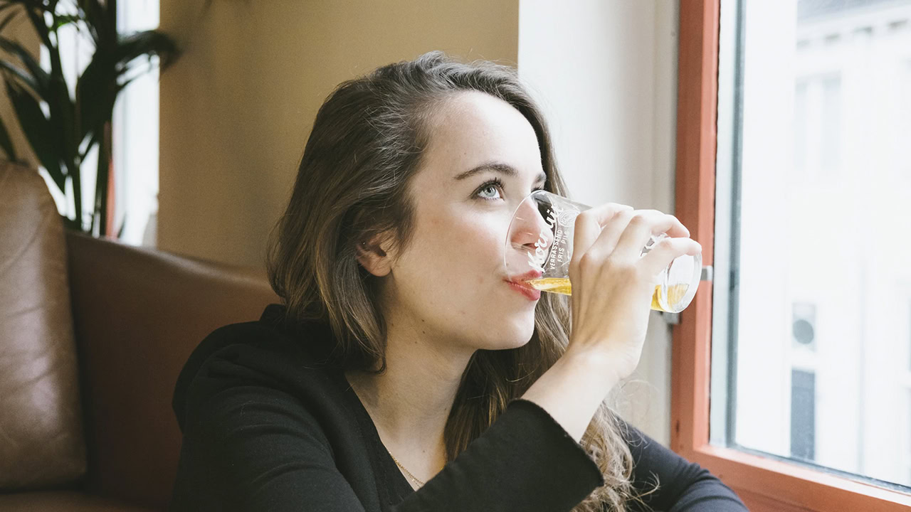 Woman enjoying a craft beer at the pub