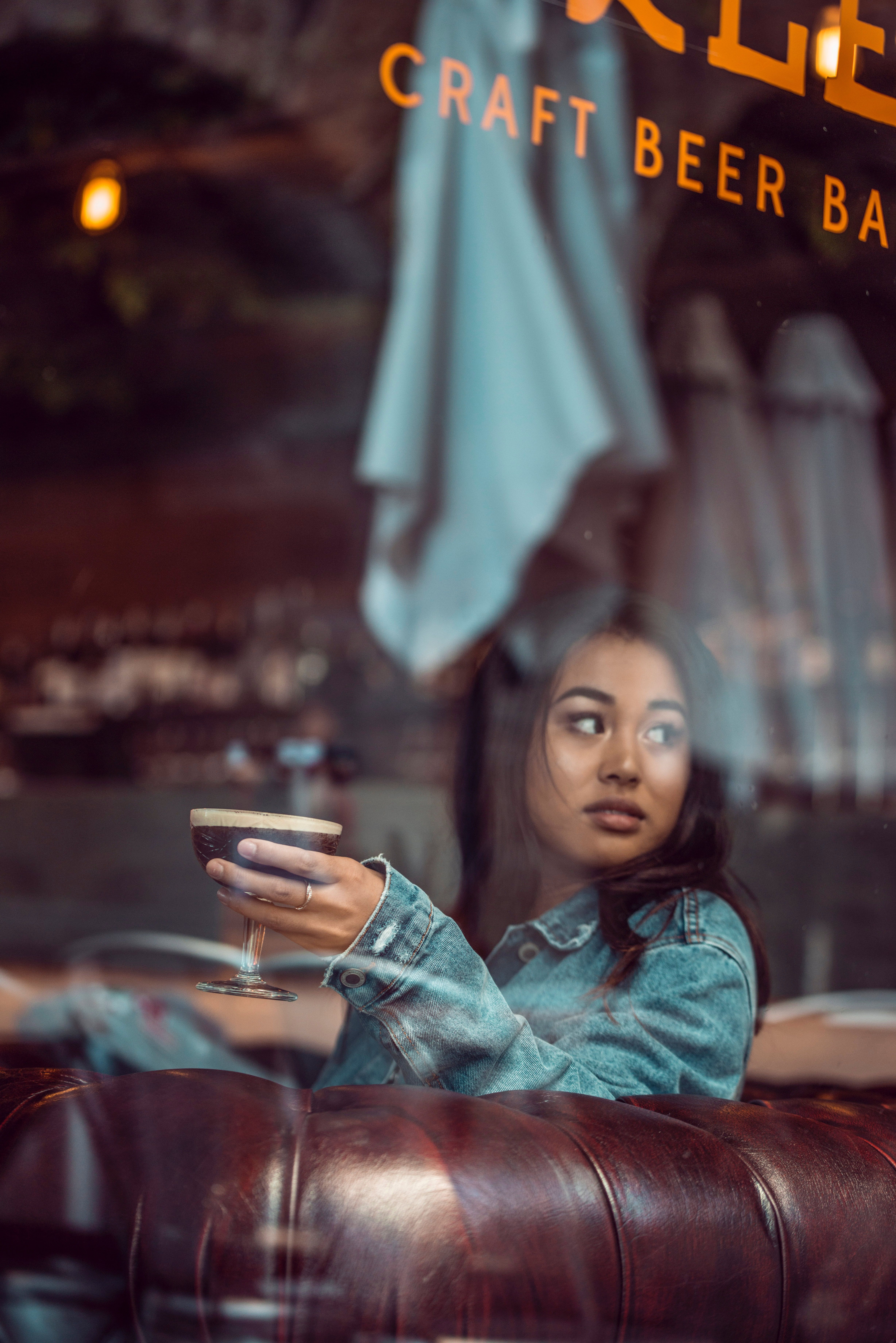 Woman enjoying a pint of beer in a pub