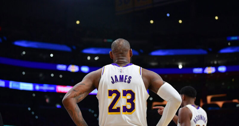 LeBron James in Lakers jersey during game, back view.