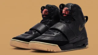 Black Air Jordan 1 sneakers with unique tongue design and beige sole.